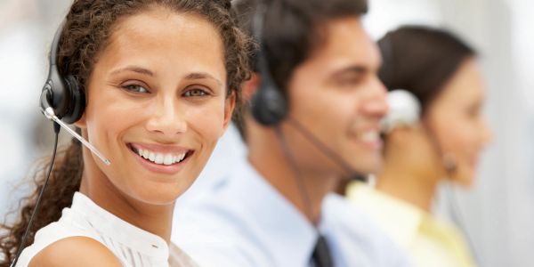 Customer service team wearing headsets in an office